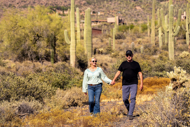 Brian Hardy and Annie Hardy walking hand in hand in the Cave Creek Arizona desert during mayoral campaign